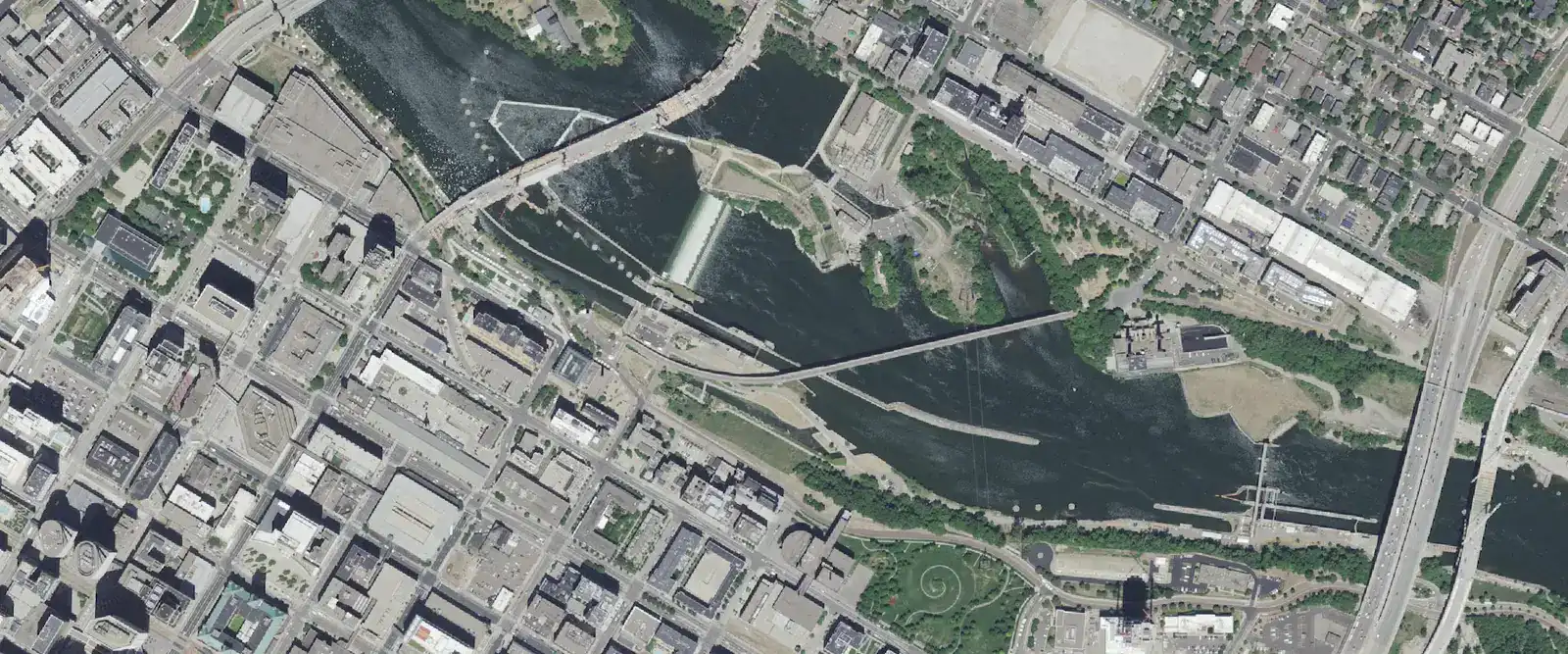 Aerial view of downtown Minneapolis, the Stone Arch Bridge and the Mississippi