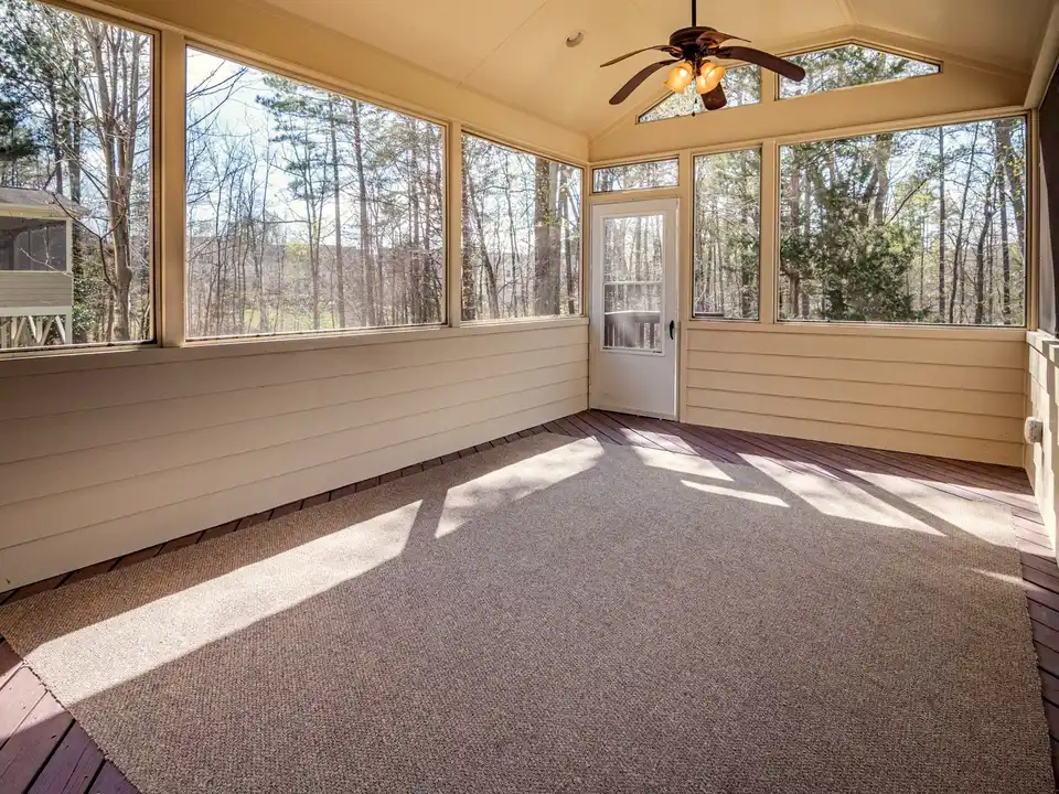A screened porch addition looking into pines