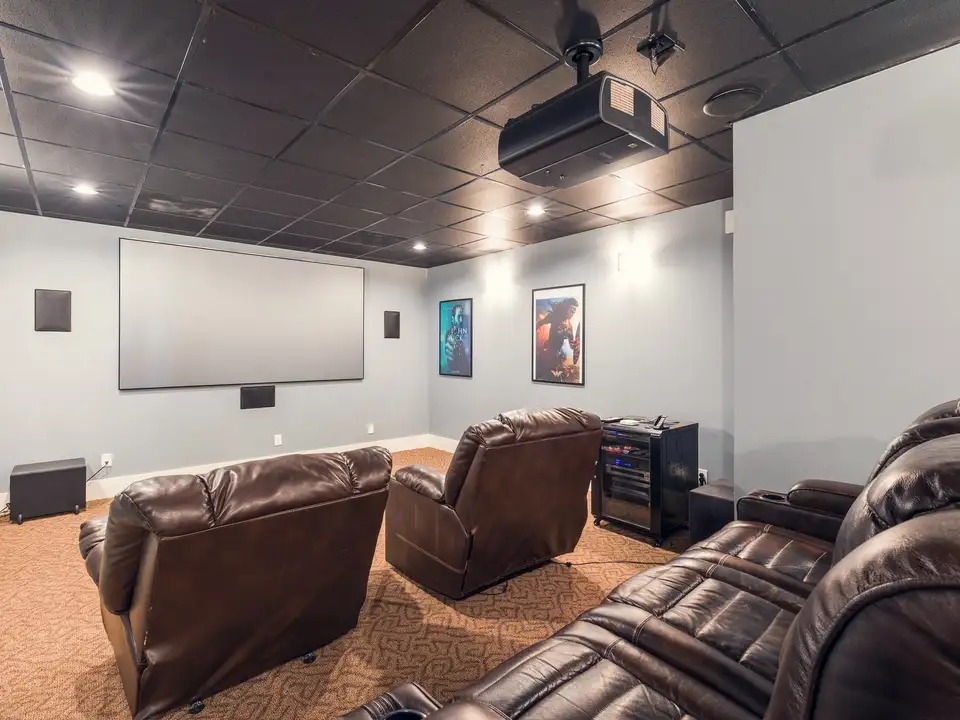 A lower-level home theatre with leather recliners