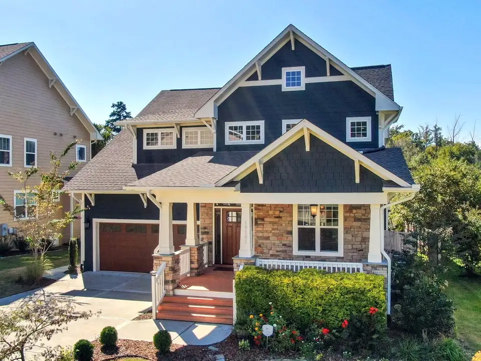 A newly built craftsman-style home with a stone-trimmed porch